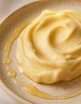 Close-up of the whipped golden tallow and raw honey balm texture